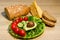 Homegrown sunflower micro green sprouts, cherry tomatoes, avocado, cucumber, green onion, bread and cheese on table.