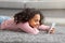 Homelanders generation. Happy african american girl using her smartphone, chatting in social media