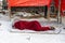 Homeless african man masai sleeping on the beach hiding behind a red plaid. Island of Zanzibar, Tanzania, Africa