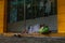 Homeless barefooted woman Sleeping on the sidewalk in front of the closed shop door, Social issue