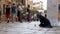 Homeless Beggar Asks for Alms in the Streets of Venice, Italy