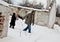 Homeless couple walking in the snow holding hands