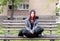 Homeless girl, Young red hair girl sitting alone outdoors with hat and shirt anxious and depressed after she became a homeless