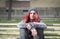 Homeless girl, Young red hair girl sitting alone outdoors with hat and shirt anxious and depressed after she became a homeless