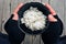 Homeless holding a bowl of rice in community food kitchen