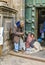 Homeless indian woman begs for money in front of the church in