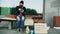 Homeless and jobless european man with cardboard sign eat sandwich on bench at city street because of immigrants crisis