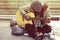 Homeless man playing guitar on walking street.