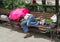 Homeless man is sleeping on a bench in the city
