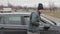 Homeless man walks up to car in public parking, male burglar robber looks through slightly open window of auto\'s