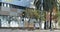 A homeless man walks by a vacant, damaged graffiti covered building