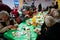 Homeless people sit around table at the Christmas charity dinner for the poor people