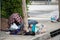 A homeless person sleeps on the sidewalk in their blanket near 8100 Haskell Ave