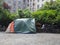 A homeless person sleeps under a tent