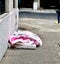 Homeless person under a childish pink cover