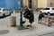 Homeless person washing his feet on the street
