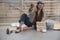 Homeless senior adult man sitting and begging