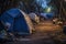 Homeless tent camp and garbage along the road in a modern evening city