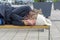 Homeless woman sleeping rough on a bench