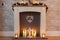 Homely Christmas mantlepiece with candles and pine cone garland