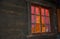 Homely vibe behind the window with glazing bars of a log cabin