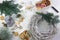 Homemade advent wreath from wood decorate with fir branches, gingerbread cookies, christmas ornaments and candles, high angle view