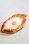 Homemade Ajarian Khachapuri with Suluguni Cheese Filled with a  Egg and Melted Butter Close Up