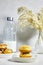 homemade Algeria Donut with apricot jam and powdered with sugar, bottle of milk and reeds vase