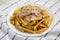 Homemade Animal Style French Fries on a white plate, side view. Close-up