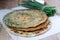 Homemade appetizing scallion pancakes and a bunch of green onions. Rustic style.