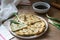 Homemade appetizing scallion pancakes and a bunch of green onions. Rustic style.