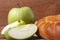 Homemade apple cake and green apple over natural wood background