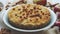 Homemade apple cake pie on blue ceramic plate with fresh apples and cinnamon sticks