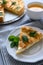 Homemade apple pie with cheese decorated mint leaves on gray wooden background. Teatime or vegetarian food concept. Selective