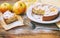 homemade apple pie on plate dusted with icing sugar, piece of ca