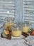 Homemade apple sauce in glass jars on rustic background