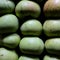 Homemade apples of different sizes perfectly stacked in a crate. Apples in a crate in a storeroom in a dark room to keep them