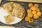 Homemade apricot cake on a plate. Freshly picked apricots on a wooden table.