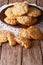 Homemade Australian ANZAC biscuits close up on a plate. vertical