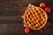 Homemade autumn apple pie, top view with frame of ingredients over dark wood