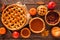 Homemade autumn pie table scene over wood. Apple, pumpkin and pecan.