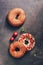 Homemade bagel with soft cheese, cherry tomatoes,basil, sesame and flax seeds on a dark rustic background. Top view, flat lay,