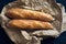 Homemade baguette bread on dark wooden table