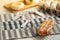 Homemade baked bakery or dessert, a bread with sausage topping with mayonnaise place on a cooling rack on striped placemat