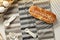 Homemade baked bakery or dessert, a bread with sausage topping with mayonnaise place on a cooling rack on striped placemat