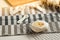 Homemade baked bakery or dessert, a white bun place on a cooling rack on striped placemat and some ingredients