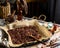 Homemade baked chocolate granola with nuts, oat flakes on baking tray with parchment stands on grey wooden table