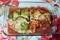 Homemade baked huge meat roll in Savoy cabbage green blanch leaves, in glass baking tray with its meat juice. cut out piece from