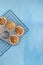 Homemade baking concept - fresh baked muffins on cooling rack, minimal picture, bright blue background, background, top view, copy