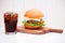 Homemade BBQ burger with coke on wooden background.